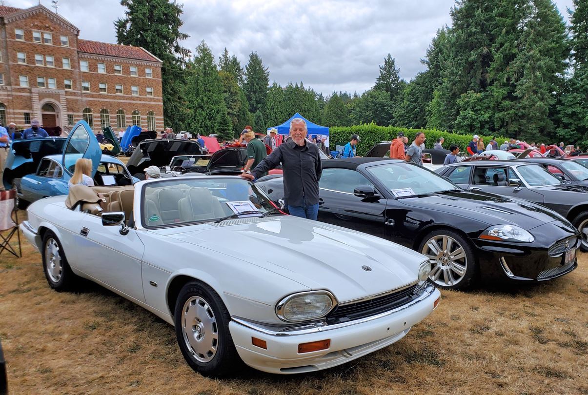Tracy Owen standing behind his 1996 XJS
